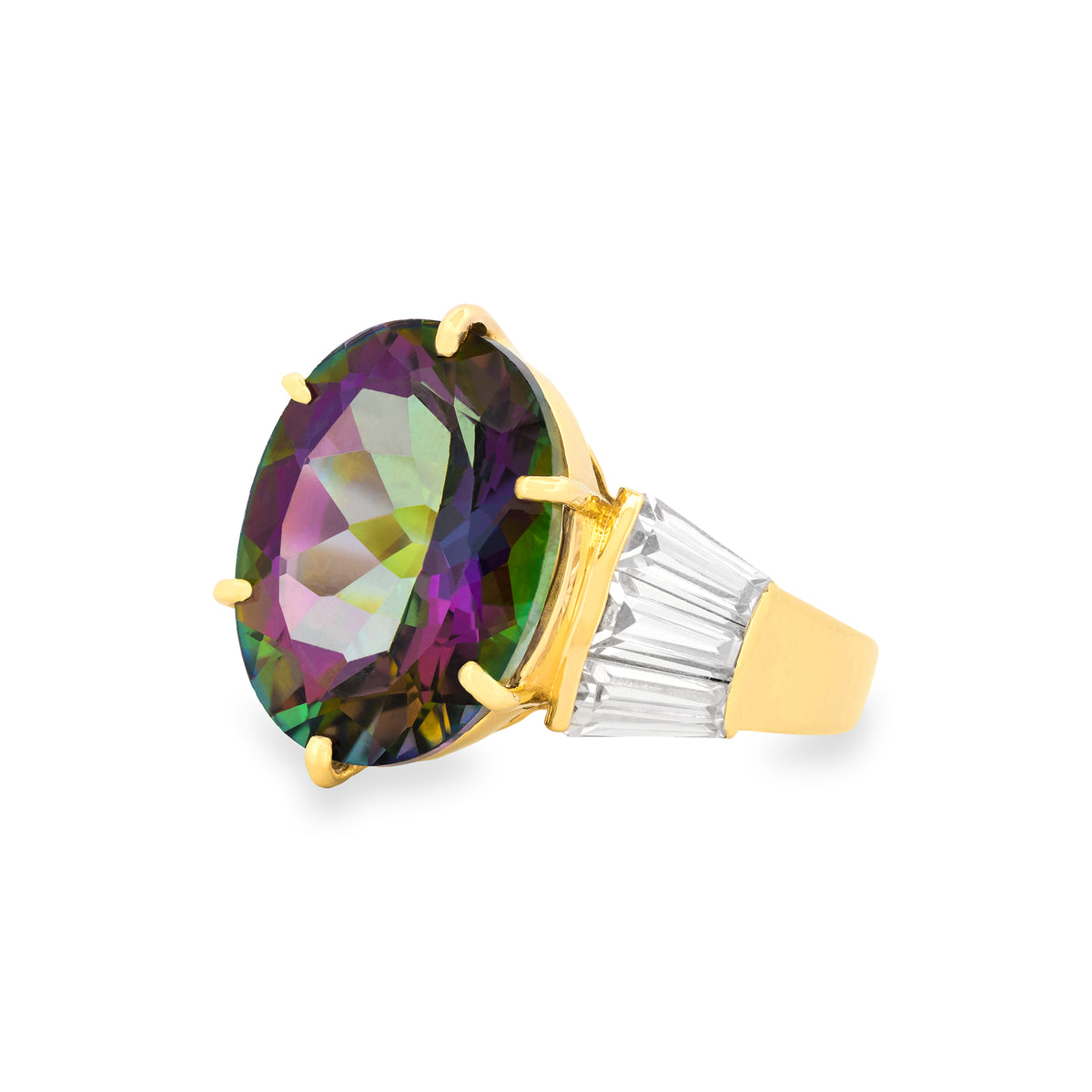 A yellow gold ring featuring a large oval faceted mystic topaz gemstone with iridescent green, purple, and pink hues, accented by baguette-cut clear crystals on the shoulders, set against a plain white background.