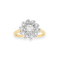 A yellow gold floral ring with a white gold cluster setting featuring a round diamonds, shown on a plain white background.