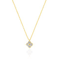 A delicate gold chain necklace with a small four-petal flower pendant set with clear gemstones, displayed on a clean white background with a soft reflection below.