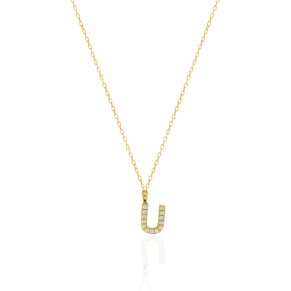 A goldtone initial necklace featuring a  letter pendant set with small clear stones, suspended from a delicate gold chain against a white background.