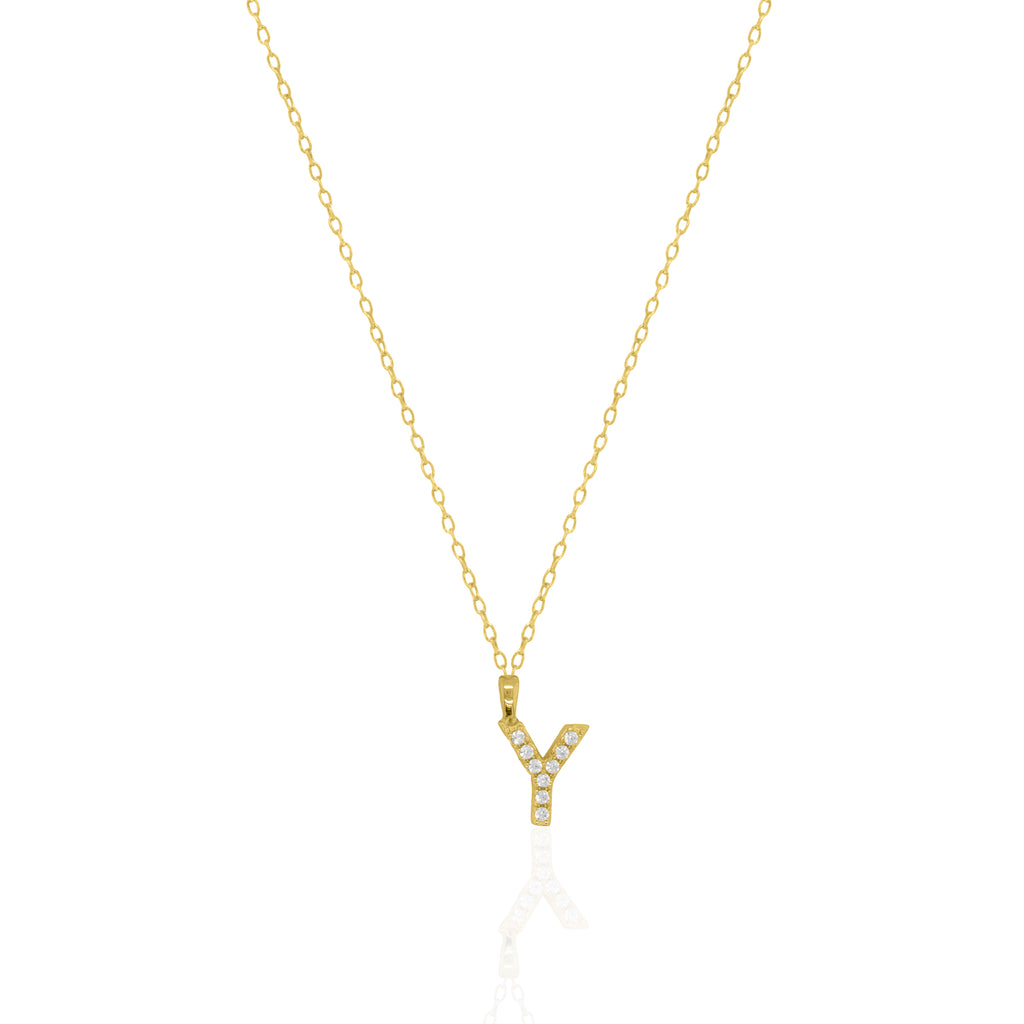 A goldtone initial necklace featuring a  letter pendant set with small clear stones, suspended from a delicate gold chain against a white background.