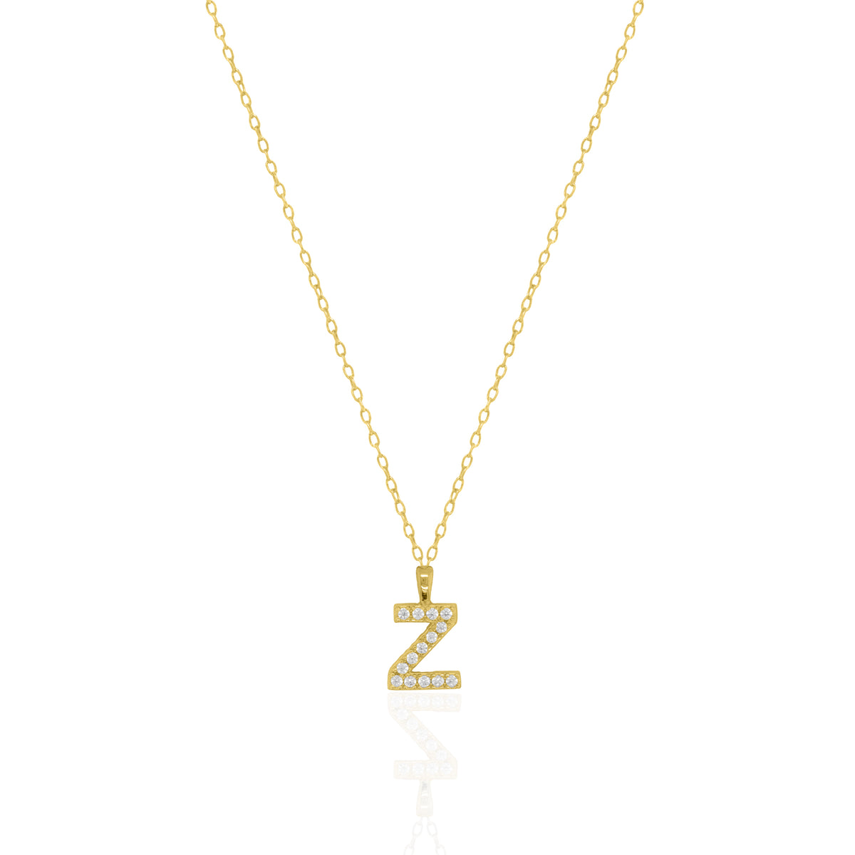 A goldtone initial necklace featuring a  letter pendant set with small clear stones, suspended from a delicate gold chain against a white background.