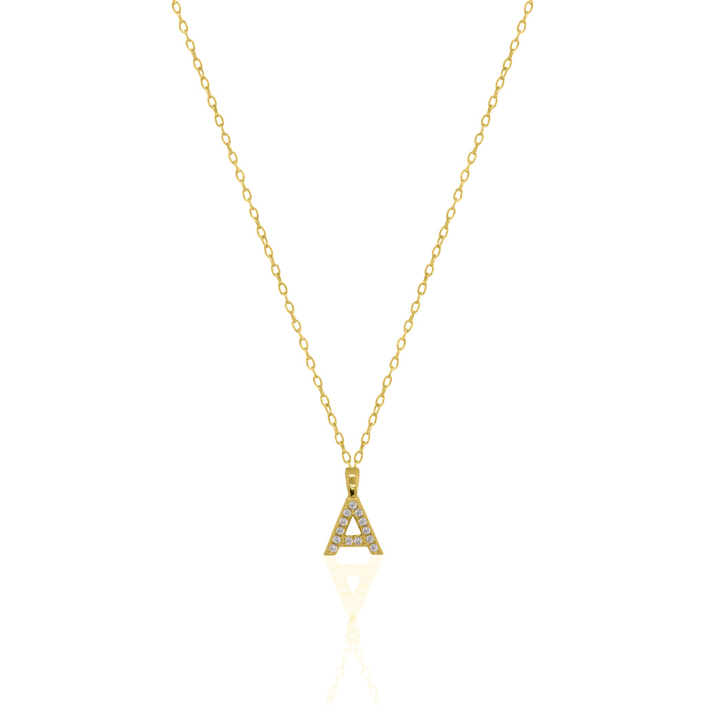 A goldtone initial necklace featuring a  letter pendant set with small clear stones, suspended from a delicate gold chain against a white background.