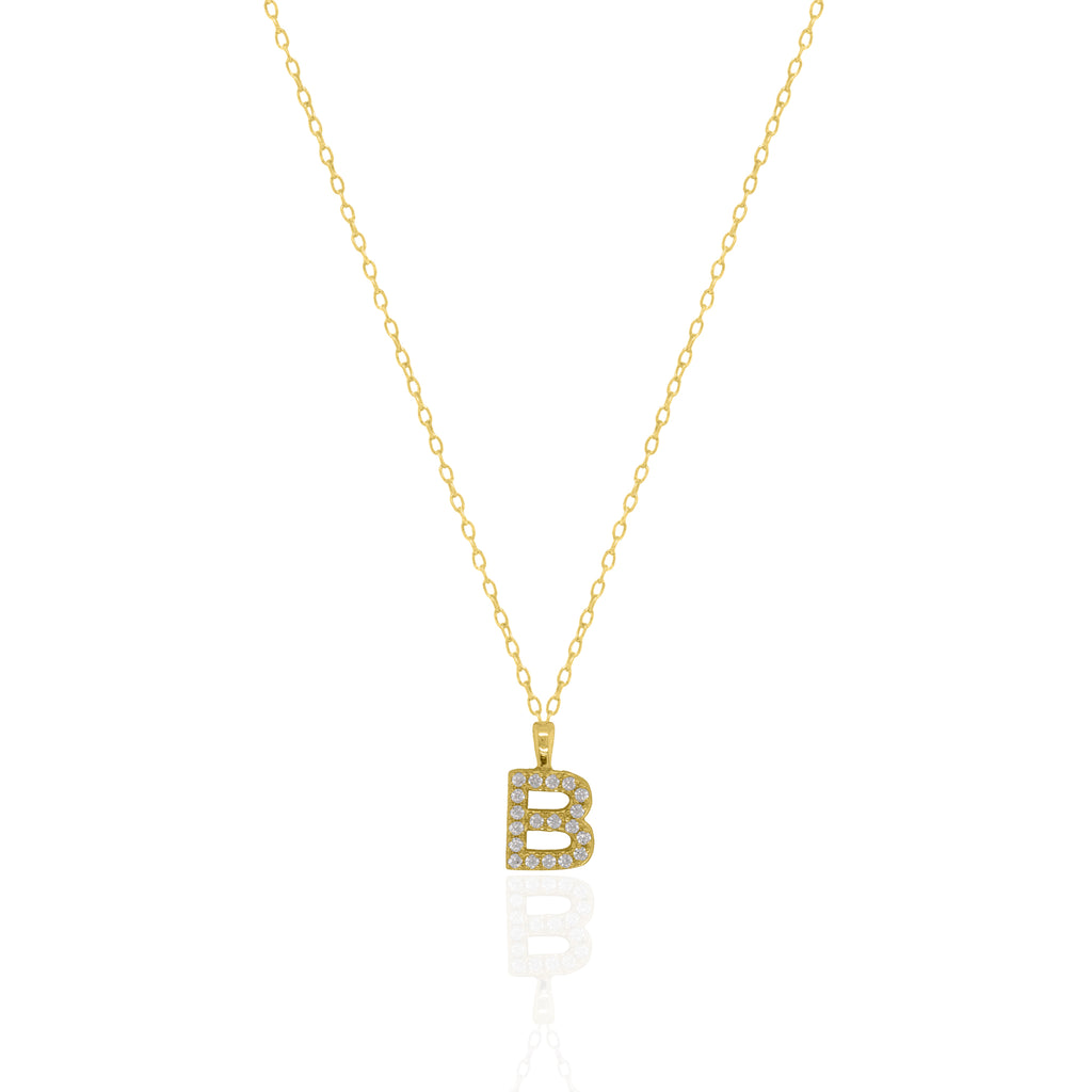 A goldtone initial necklace featuring a  letter pendant set with small clear stones, suspended from a delicate gold chain against a white background.