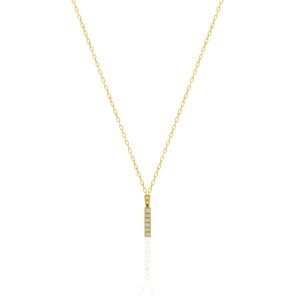 A goldtone initial necklace featuring a  letter pendant set with small clear stones, suspended from a delicate gold chain against a white background.