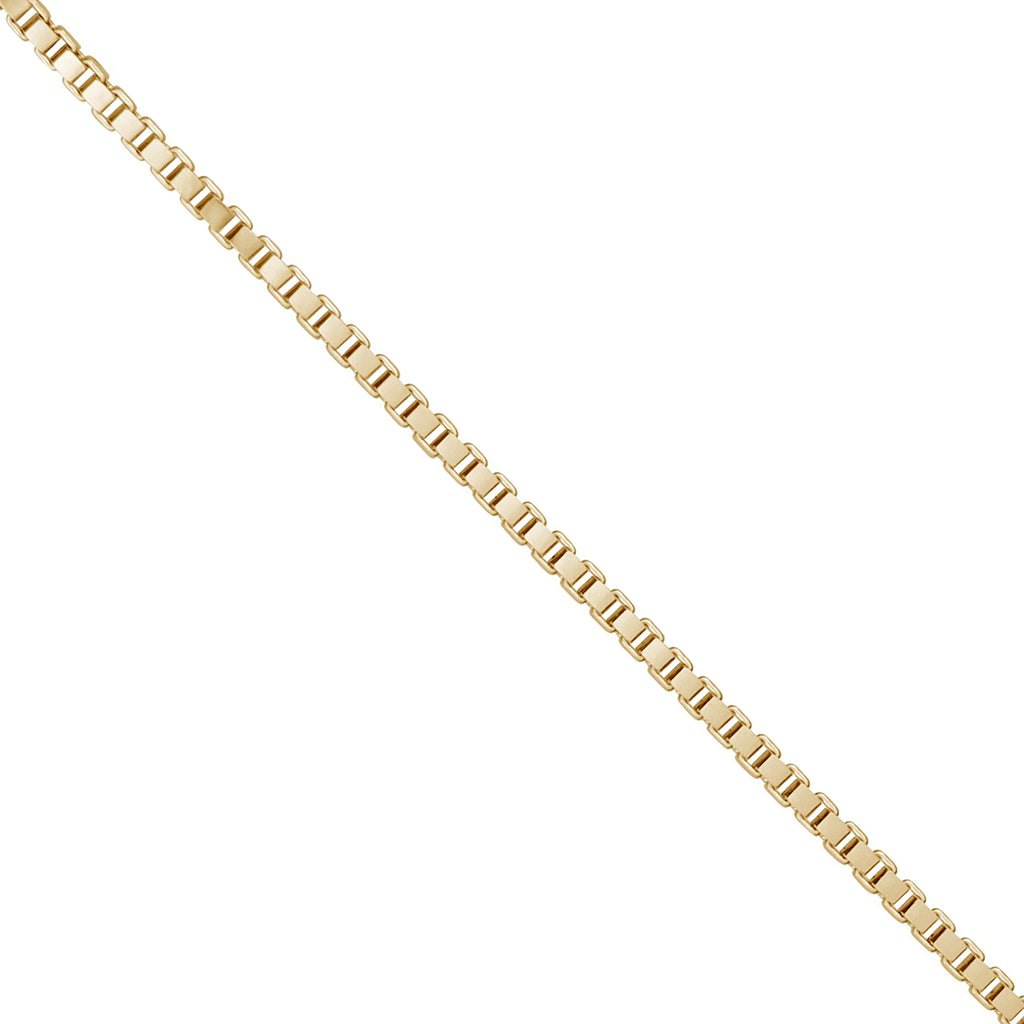 A close-up of a yellow gold box chain link against a plain white background.