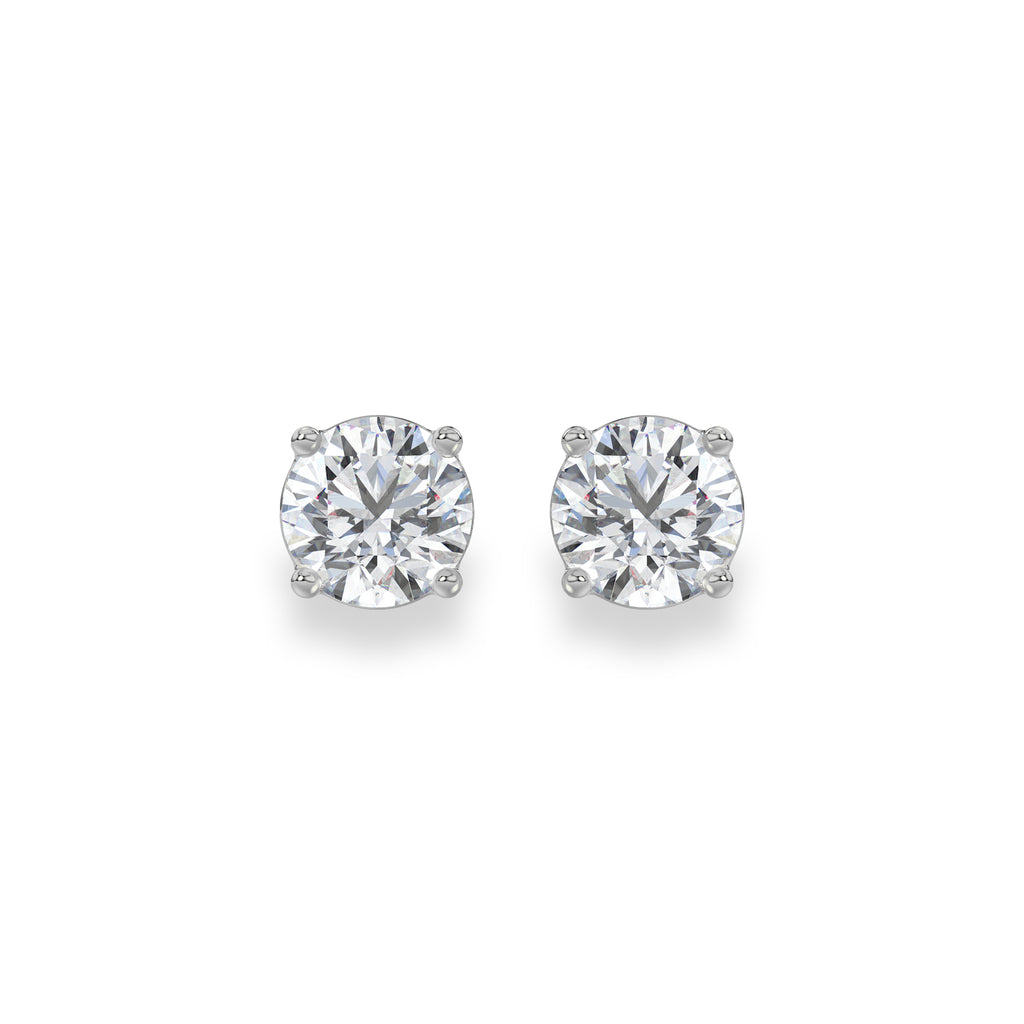 A pair of round-cut diamond stud earrings in a silver four-prong setting, displayed on a clean white background.