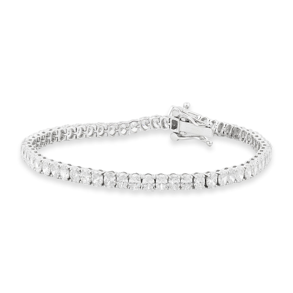 A white gold tennis bracelet with a continuous row of clear diamonds shown on a plain white background.