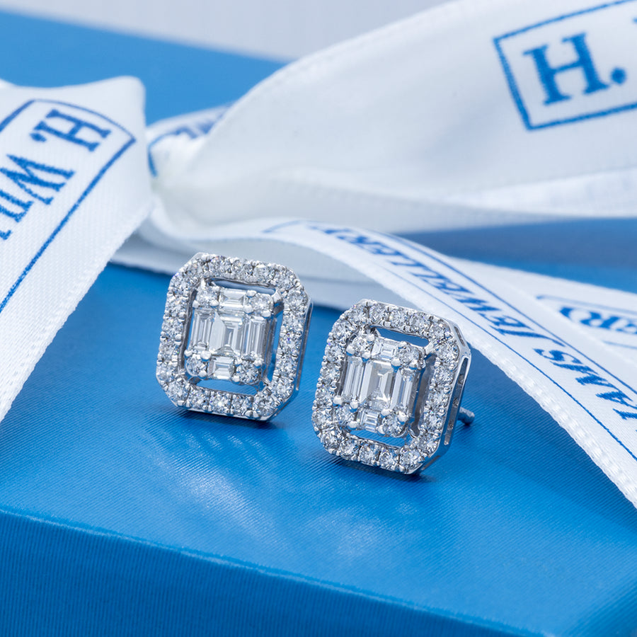 Pair of diamond earrings on a blue box with white H. Williams Jewellery ribbon.