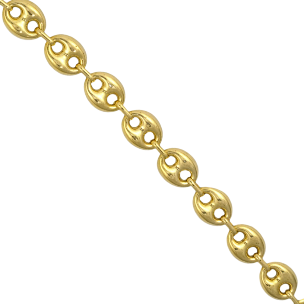 A close-up of a yellow gold gucci chain link against a plain white background.