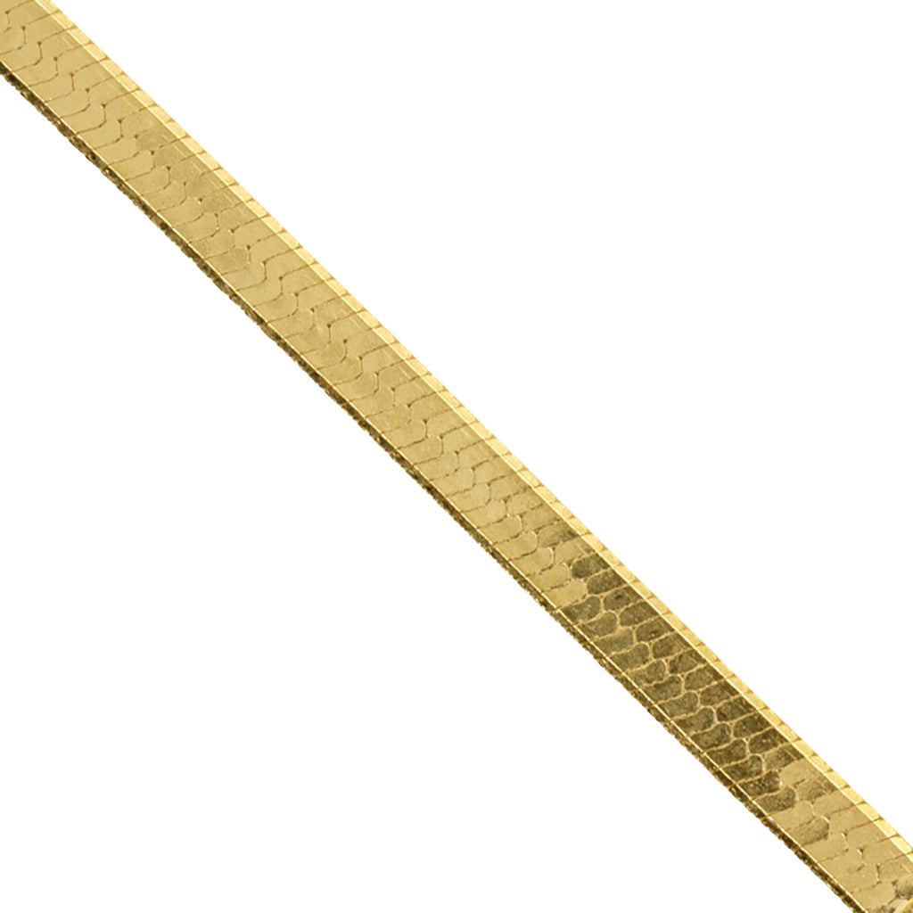 A close-up of a yellow gold herringbone chain against a plain white background.