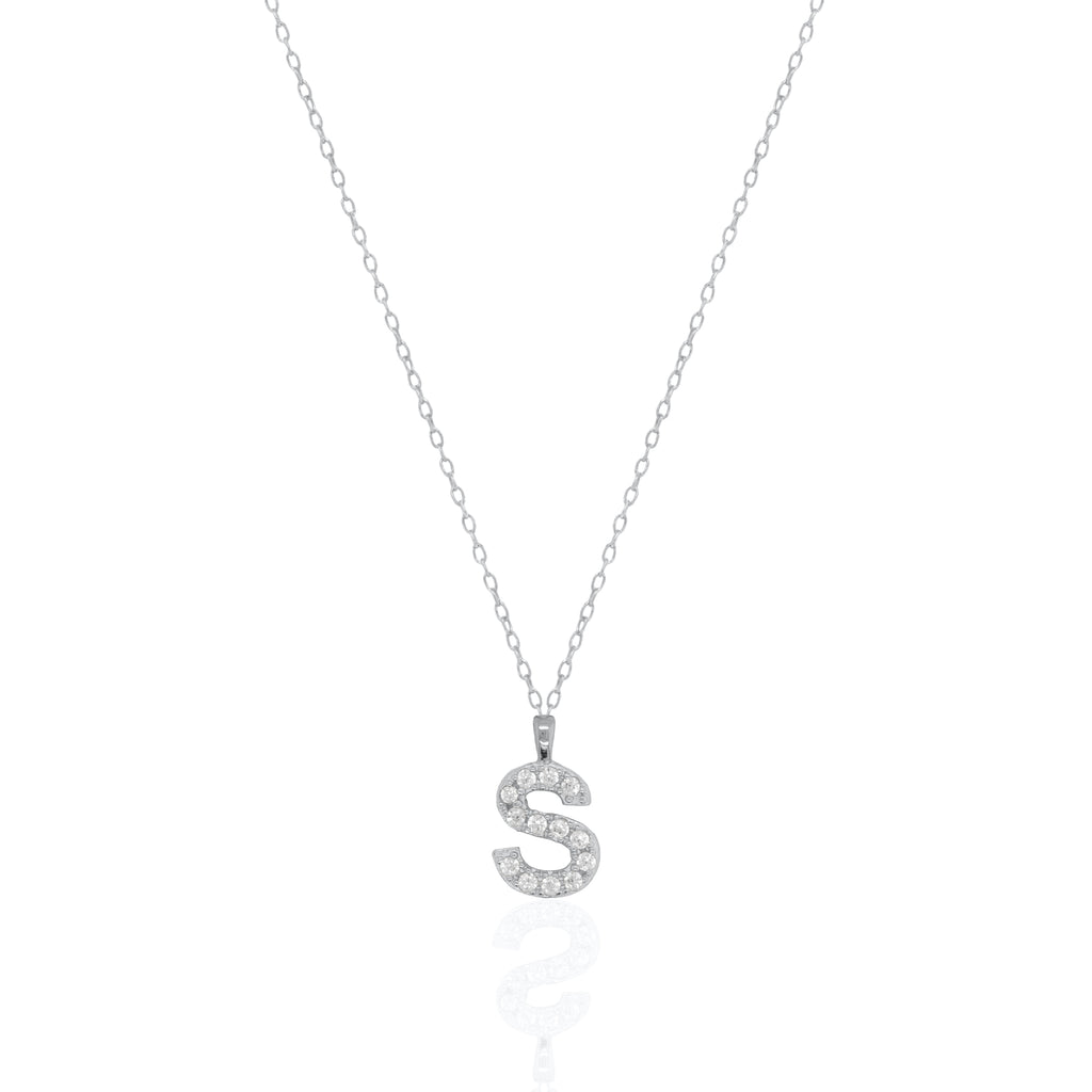 A silver initial necklace featuring a  letter pendant set with small clear stones, suspended from a delicate gold chain against a white background.