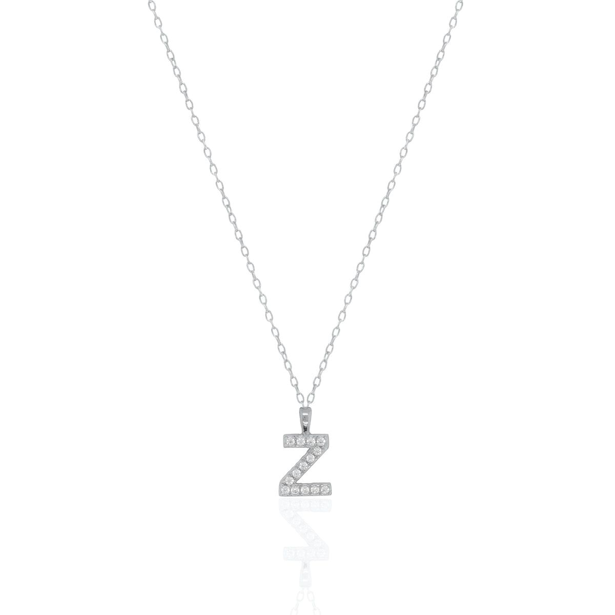 A silver initial necklace featuring a  letter pendant set with small clear stones, suspended from a delicate gold chain against a white background.