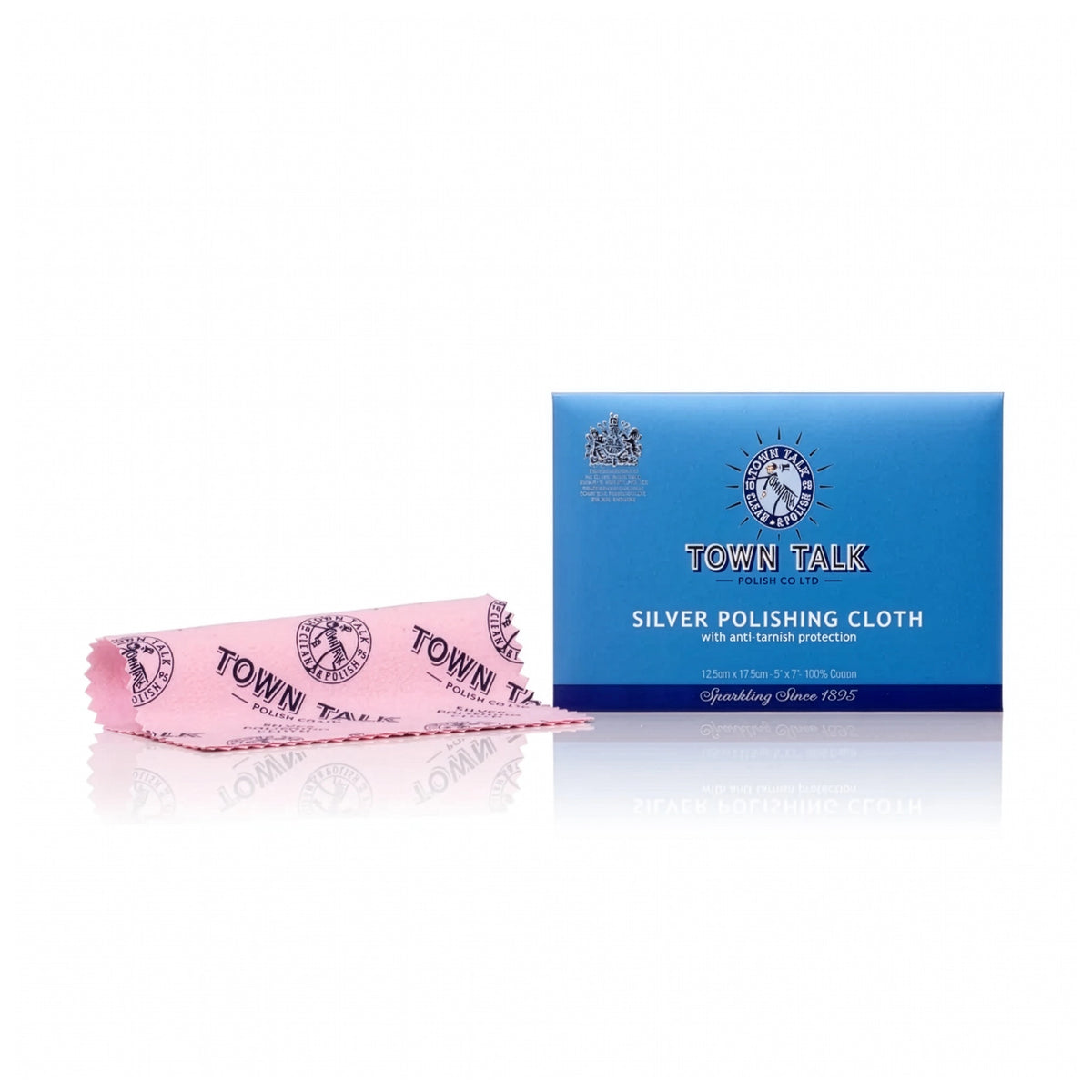 A pink Town Talk silver polishing cloth with a fringed edge is displayed next to its blue packaging box on a reflective white surface.